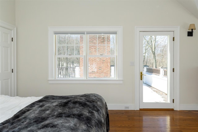 bedroom with access to exterior, dark wood finished floors, and baseboards