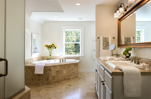 bathroom with double vanity, a bath, tile patterned floors, a sink, and recessed lighting