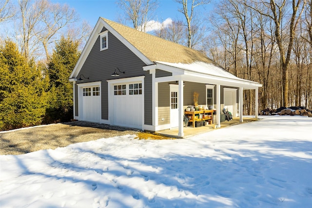 snow covered garage with a garage