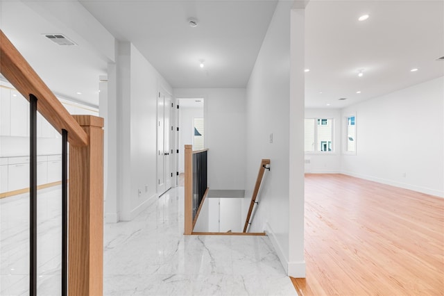 corridor featuring visible vents, recessed lighting, an upstairs landing, and baseboards