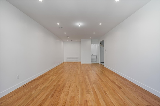 spare room featuring baseboards, recessed lighting, visible vents, and light wood-style floors