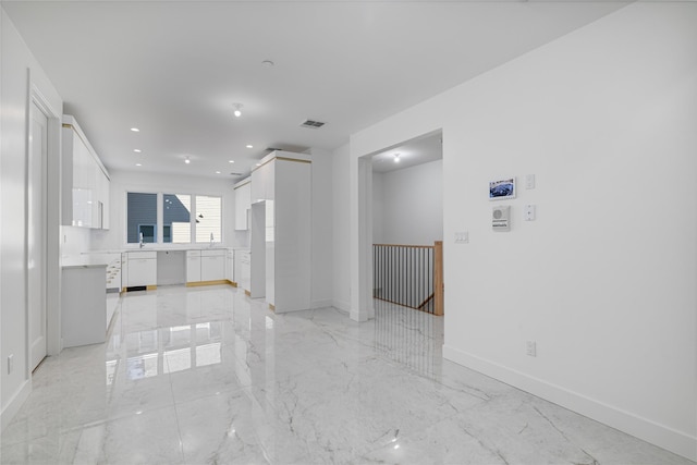 unfurnished living room featuring marble finish floor, recessed lighting, visible vents, and baseboards