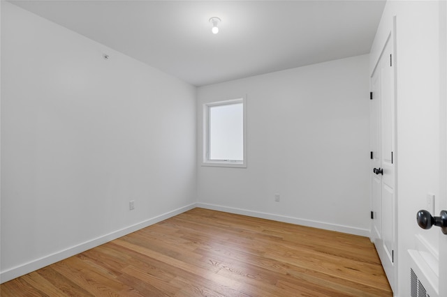 unfurnished room with light wood-style floors and baseboards