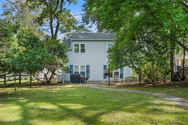 rear view of house with a lawn