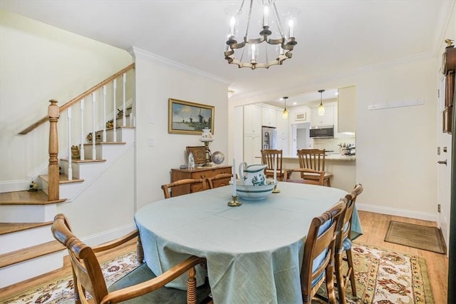 dining area with ornamental molding, stairway, an inviting chandelier, light wood finished floors, and baseboards