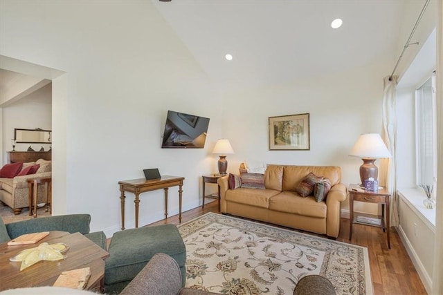 living area featuring recessed lighting, high vaulted ceiling, baseboards, and wood finished floors