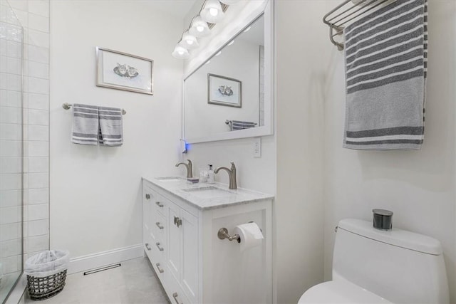 full bathroom featuring toilet, baseboards, visible vents, and a sink