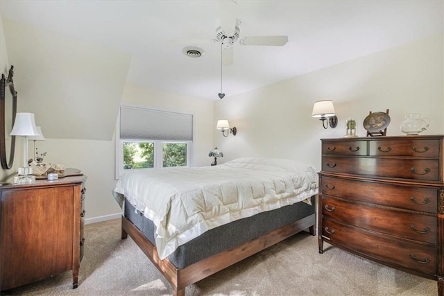 carpeted bedroom featuring visible vents, ceiling fan, baseboards, and vaulted ceiling