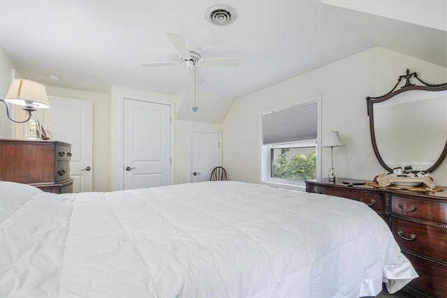 bedroom with visible vents, a ceiling fan, and lofted ceiling