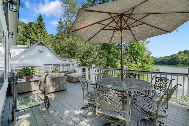 deck featuring an outdoor hangout area, outdoor dining space, and a water view