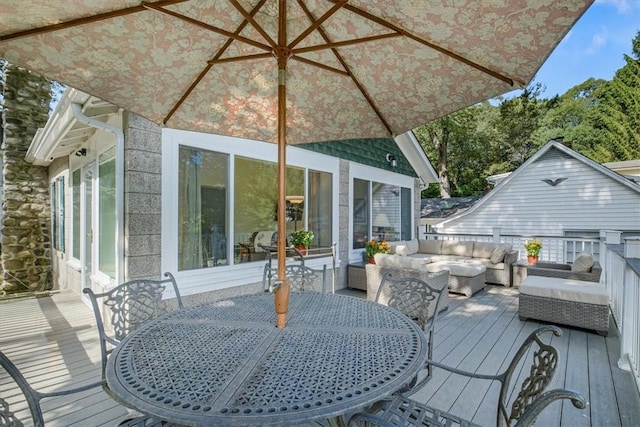 wooden terrace featuring outdoor dining area and an outdoor hangout area