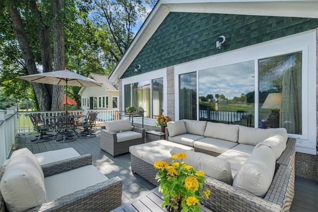 wooden terrace featuring outdoor dining space and an outdoor hangout area