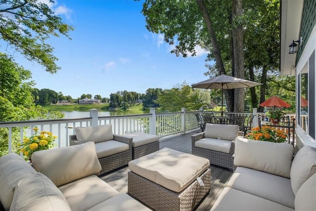 deck featuring an outdoor living space and a water view