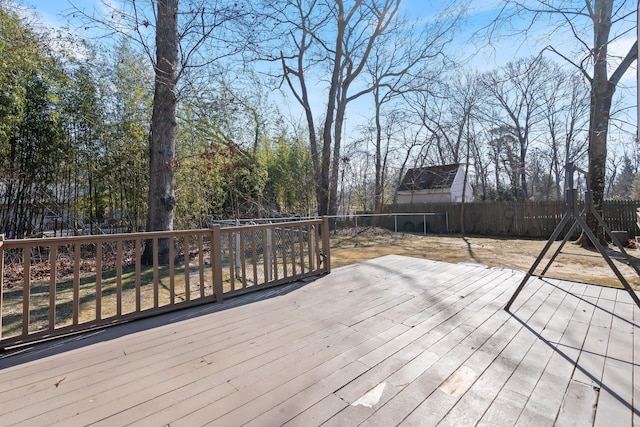 wooden terrace featuring fence