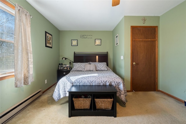 carpeted bedroom featuring baseboards, multiple windows, a baseboard heating unit, and a ceiling fan