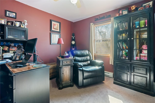 home office featuring a baseboard heating unit, ceiling fan, and carpet floors