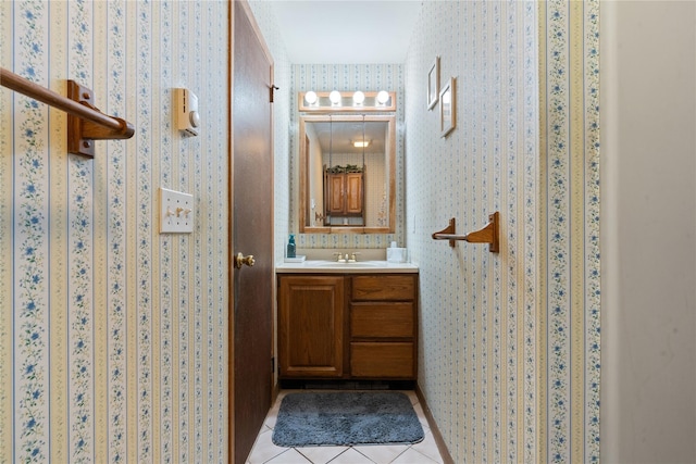 bathroom with tile patterned flooring, vanity, and wallpapered walls