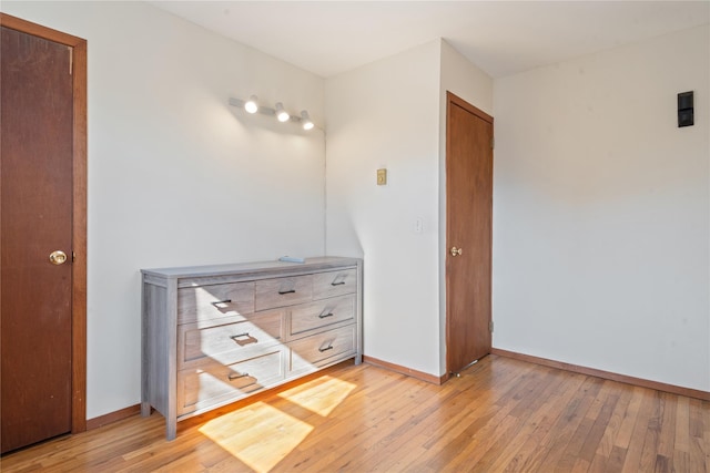 unfurnished bedroom with light wood finished floors and baseboards