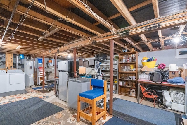 unfinished basement with water heater, separate washer and dryer, and freestanding refrigerator