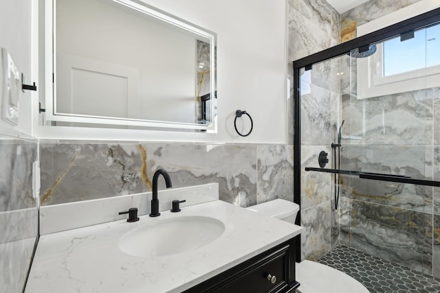 430 Wellington Rd, East Meadow, NY 11554 - full bathroom with a stall shower, wainscoting, toilet, vanity, and tile walls