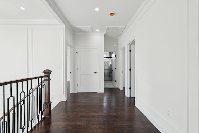430 Wellington Rd, East Meadow, NY 11554 - corridor with a decorative wall, dark wood-style flooring, an upstairs landing, attic access, and crown molding