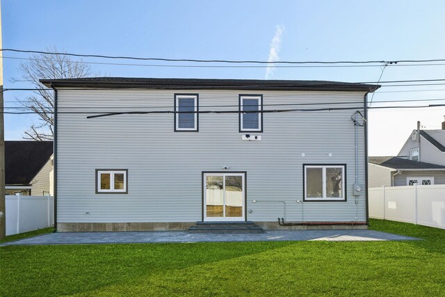 430 Wellington Rd, East Meadow, NY 11554 - back of house with entry steps, a yard, and a fenced backyard