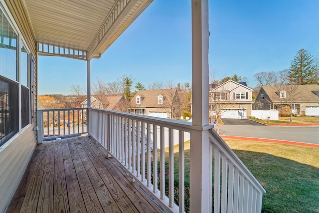 deck with a yard and a residential view