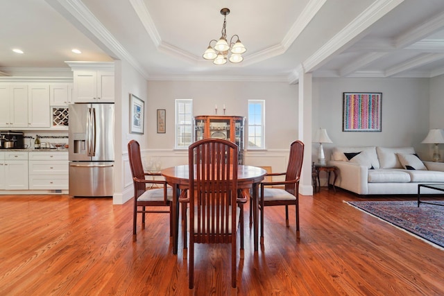 dining room with recessed lighting, an inviting chandelier, light wood-style floors, and ornamental molding