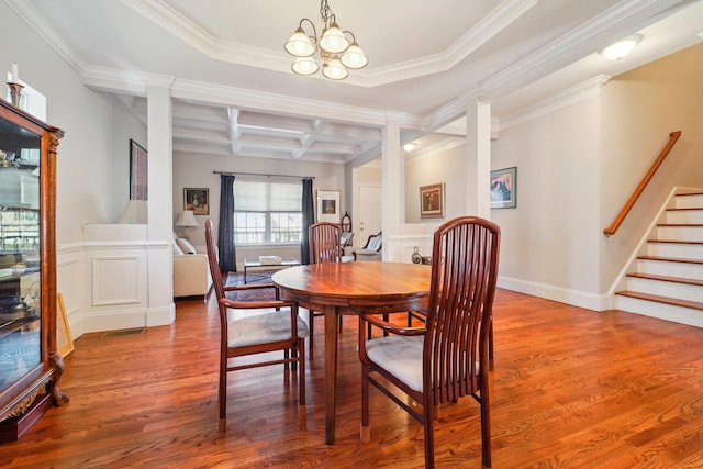 dining space featuring beamed ceiling, stairs, an inviting chandelier, wood finished floors, and coffered ceiling