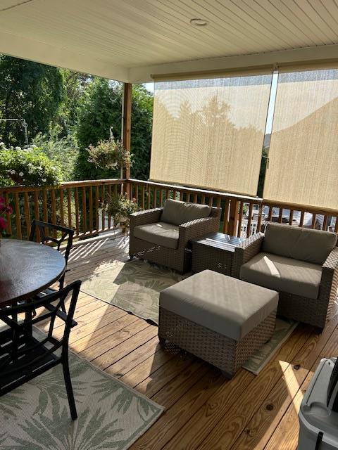 wooden deck featuring outdoor lounge area and outdoor dining area