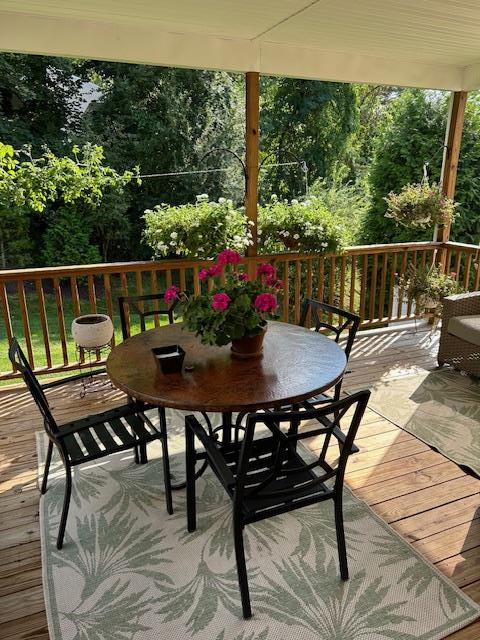 deck with outdoor dining area