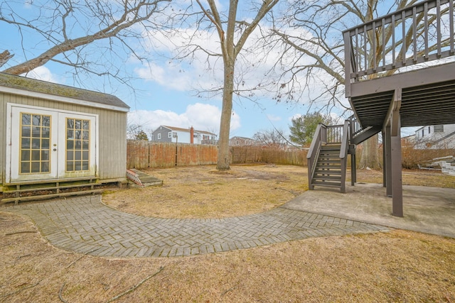 view of yard with entry steps, a patio, stairway, fence, and a wooden deck