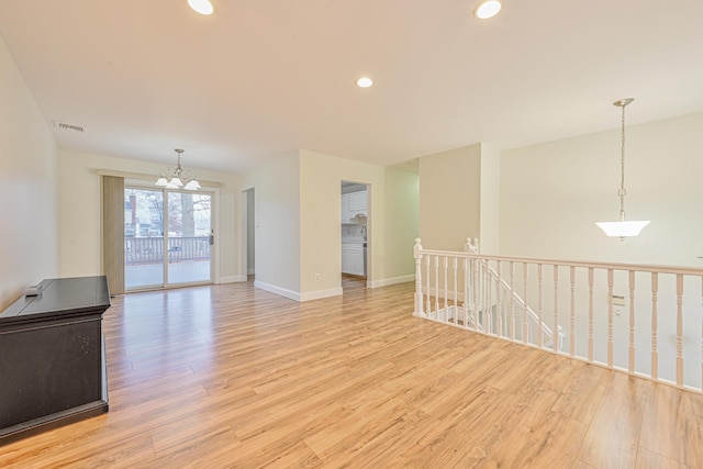 unfurnished room featuring light wood-style floors, recessed lighting, visible vents, and baseboards