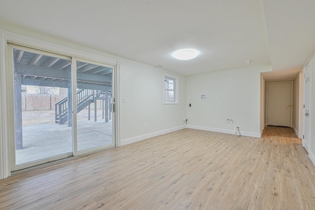 spare room with light wood-type flooring and baseboards