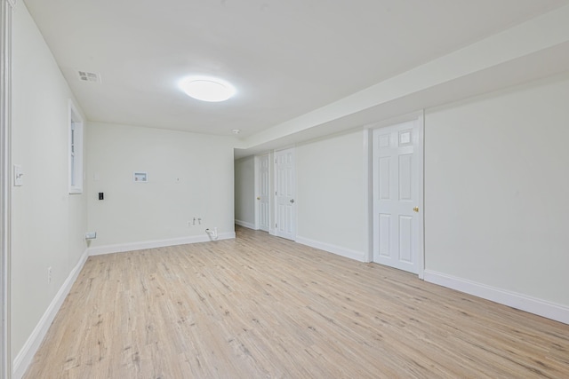 interior space featuring light wood-type flooring, visible vents, and baseboards