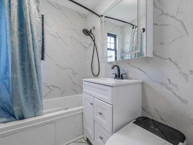 full bathroom with marble finish floor, shower / bathtub combination with curtain, and vanity