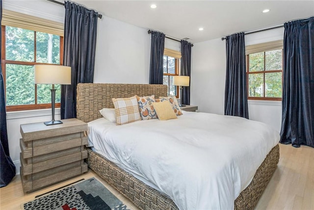 bedroom with wood finished floors and recessed lighting