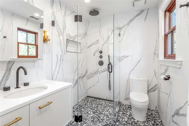 bathroom with visible vents, vanity, a marble finish shower, and toilet