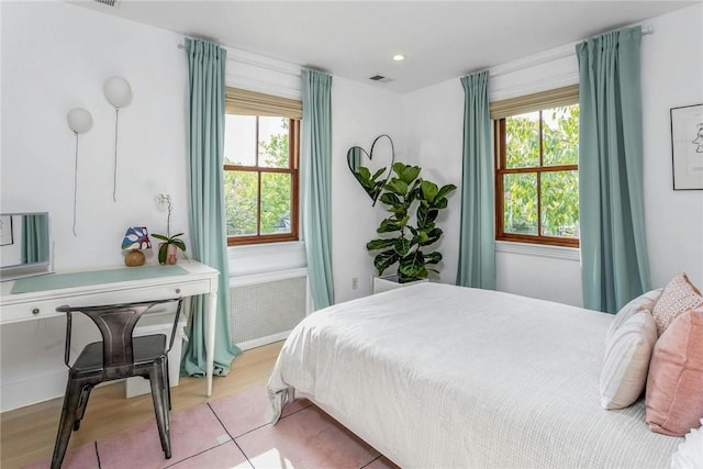 bedroom featuring multiple windows, visible vents, wood finished floors, and recessed lighting