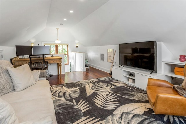 living area with lofted ceiling, visible vents, and wood finished floors