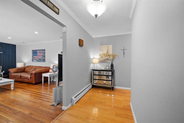 corridor featuring ornamental molding, light wood-type flooring, baseboards, and a baseboard radiator