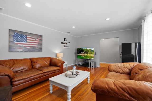 living area featuring recessed lighting, wood finished floors, baseboards, and ornamental molding