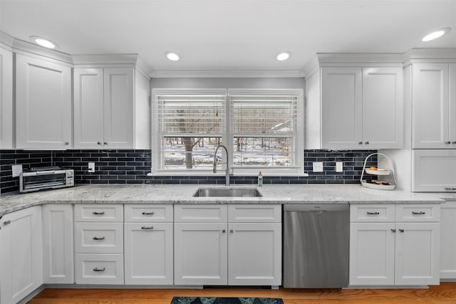 kitchen featuring a sink, backsplash, white cabinets, a toaster, and dishwasher