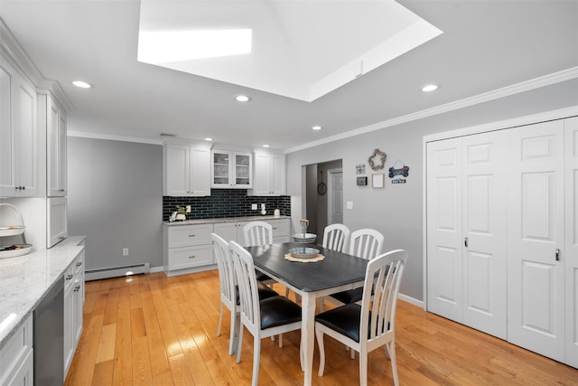 dining space with a baseboard heating unit, recessed lighting, light wood-type flooring, and ornamental molding