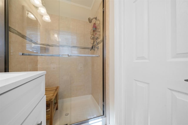 bathroom featuring vanity, crown molding, and a stall shower