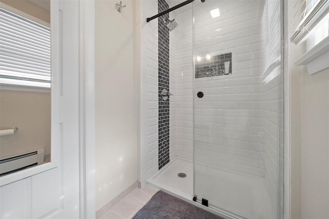 full bath featuring tile patterned flooring, baseboard heating, and a shower stall