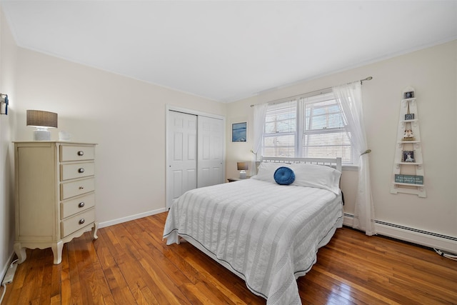 bedroom with a closet, baseboards, and hardwood / wood-style floors