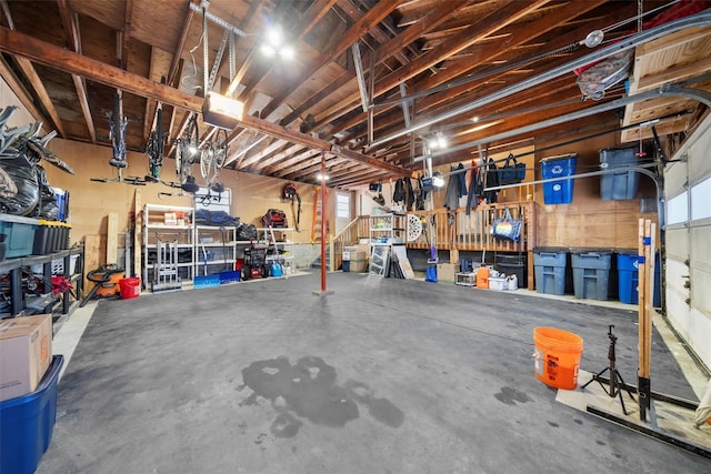 garage with a workshop area and a garage door opener