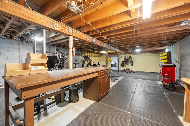 unfinished basement featuring a workshop area