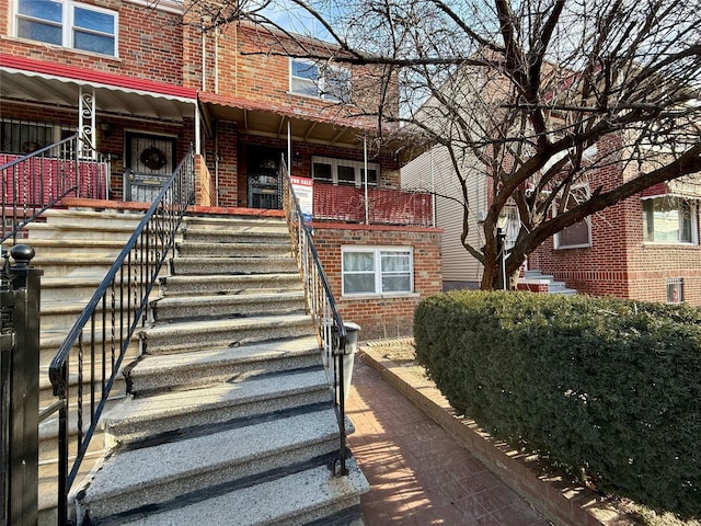 doorway to property featuring brick siding